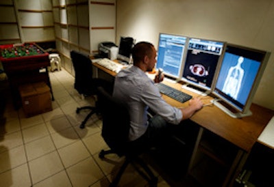 Home office showing a radiologist on duty. 'This integration of information, images, and reporting tools is unique in today's market,' said Dr. Johan de Mey, head of the UZB radiology group. Image courtesy of Filip Verhelle.