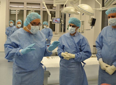 A typical training session at AMTS. Dr. Pietro Regazzoni (shown in the center of the picture, with arms raised) believes industrial partners benefit from directly learning the needs of frontline healthcare staff and management through simulated work flow.