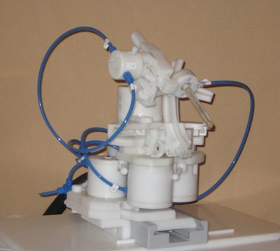 First-generation robotic device, showing blue tubes that deliver compressed air to the pneumatic motors. Image courtesy of Dr. Martijn Schouten.