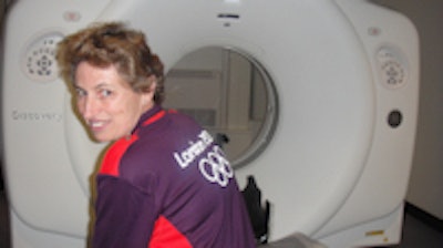 Ready for action: Alison Tuck, CT clinical specialist radiographer from Kingston Hospital, U.K., proudly models the purple shirt to be worn by all polyclinic staff during the games. Medical staff won't wear white coats.