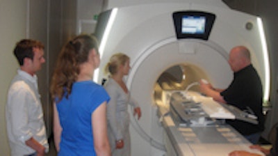Dylan Pritchard (right), MRI clinical education leader EMEA at GE Healthcare, conducts a training session in the Olympics polyclinic on the Discovery MR750w wide-bore 3-tesla MRI system.