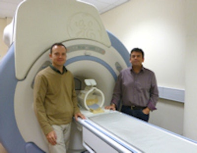 Richard Wise and Krish Singh by CUBRIC's mock MRI system. Equipped with stimulus delivery systems, this system is used to test experimental ideas on volunteers in a realistic imaging environment, as well as helping them to acclimatize to the MRI environment.