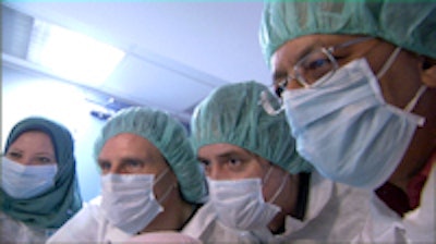 Eyes down: Intense concentration and sterile conditions were required at the Cairo laboratory. Shown here are molecular biologist Carsten Pusch, paleopathologist Albert Zink, molecular geneticist Yehia Gad, and molecular biologist Ahmed Gad. Copyright: A. Zink.