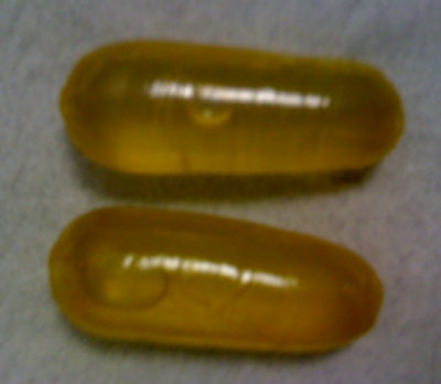 Photos of a handmade packet (left) and two packets (right) consisting of a condom filled with cocaine in solution.