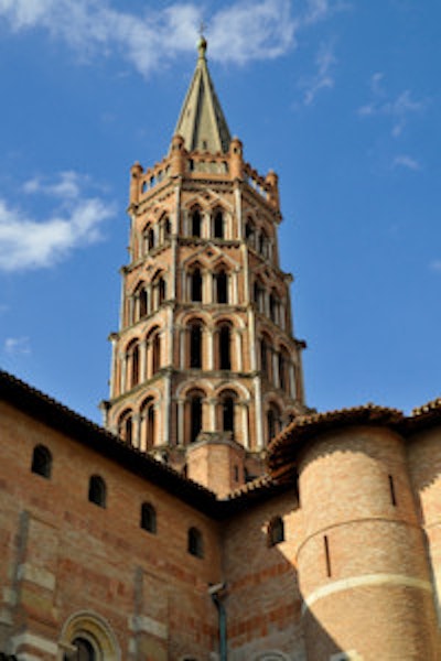 The organizers of the ESMRMB congress chose the bell tower of the St. Sernin Basilica in Toulouse, France, as their main image. The church is located on the site of a previous basilica from the fourth century, which contained the body of Saint Saturnin or Sernin, the first bishop of Toulouse. Most of the current building was constructed in the Romanesque style between about 1080 and 1120, and it became a UNESCO World Heritage Site in 1998.