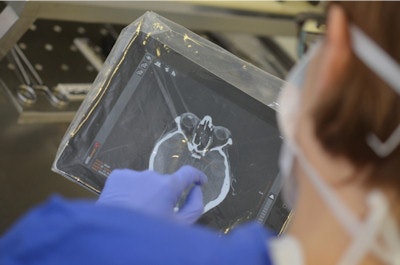 Forensic pathologist viewing CT data at autopsy site using MITKPocket. Interaction with two pairs of gloves (thin nitrile gloves and thicker autopsy gloves) and a protective covering for iPad (transparent singular use plastic bag).