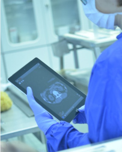 Forensic pathologist viewing CT data using MITKPocket right before performing autopsy. Interaction with two pairs of gloves (thin nitrile gloves and thicker autopsy gloves). All images courtesy of Ignaz Reicht.