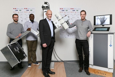 The GlobalDiagnostiX prototype and leadership team. From the left: Bertrand Klaiber, technology transfer manager from the Cooperation & Development Center at the EPFL (Swiss Federal Institute of Technology in Lausanne); Dr. Jean-Roger Moulion Tapouh, a radiologist at the University Hospital Yaoundé Cameroon and project manager in Africa; Dr. Klaus Schönenberger, program leader; Romain Sahli, project manager Switzerland, EPFL. Image courtesy of Alain Herzog, EPFL.