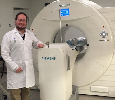 Nicolas Karakatsanis displays the PET/CT scanner.