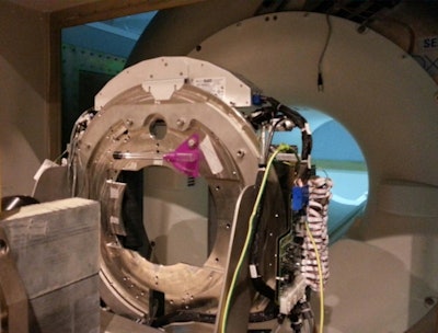 The Australian collaboration's first prototype MRI-linac combined a portable linac with an on loan ex-clinical 1.5-tesla MRI scanner. The shielded linac (yellow) is visible on the far left. The multileaf collimator is in the middle of the photo. A copper RF screen has been removed to show the magnet.