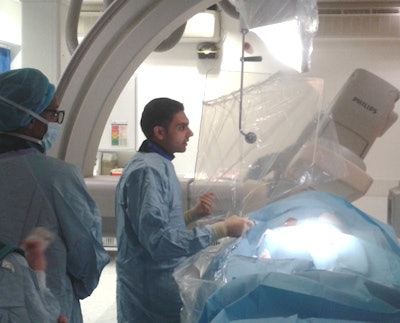 Will state-of the art imaging be threatened by Brexit's impact on radiological research? Here, interventional neuroradiology fellow, Dr. Ayman Qureshi and other interventional radiology staff, perform a procedure at King's College Hospital. All images courtesy of Dr. Thomas Booth, PhD.