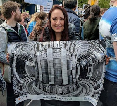 French citizen Alexandrine Kántor is shown here holding a poster about Euratom's Joint European Torus project aimed at investigating the safety of fusion power.