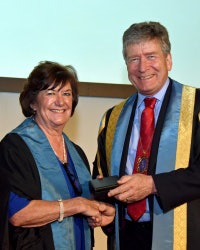 Prof. Judith Adams receives an award from past RCR President Dr. Giles Maskell in 2016. Image courtesy of the RCR.