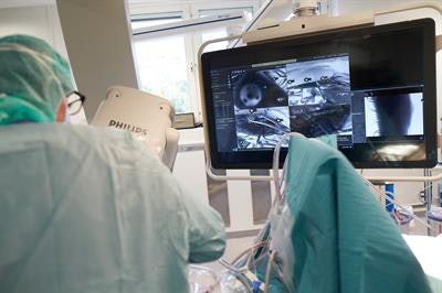 A surgeon using the augmented reality navigation technique to insert pedicle screws for spinal surgery. Image courtesy of Rami Nachabé, PhD.