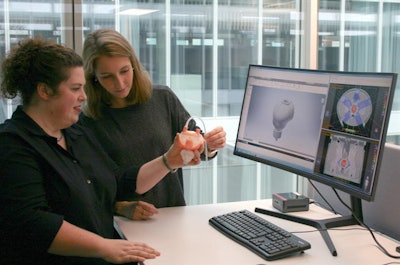 First author Alina Elter (right) and Wibke Johnen, the medical technician responsible for the design of 3D-printed objects, discuss a new 3D-printed prostate attached to a silicone bladder for use in an anthropomorphic pelvis phantom. Photo courtesy of Alina Elter.