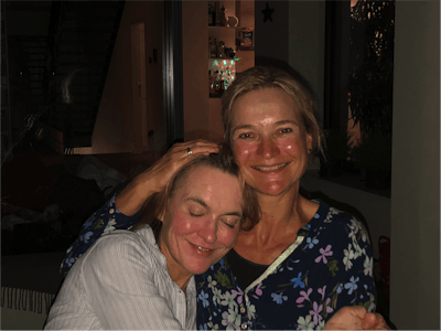 Christiane (left) enjoys a hug from sister Gitta last November.