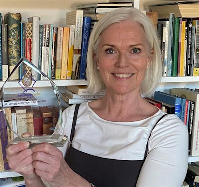 In safe hands: Berit Bringedal, PhD, proudly displays the EuroMinnies trophy.