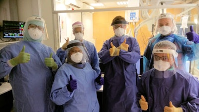 COVID-19 won't destroy our spirit: the interventional neuroradiology team at King's College Hospital, including nurses and radiographers. All images courtesy of Dr. Tom Booth, PhD.