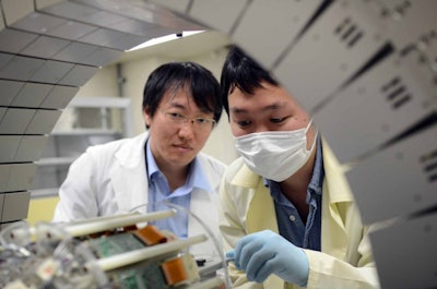 First author Hideaki Tashima, PhD, (left) and co-author Hidekatsu Wakizaka (right) image a mouse using a whole gamma imaging platform. Image courtesy of Taiga Yamaya, PhD, National Institute of Radiological Sciences.