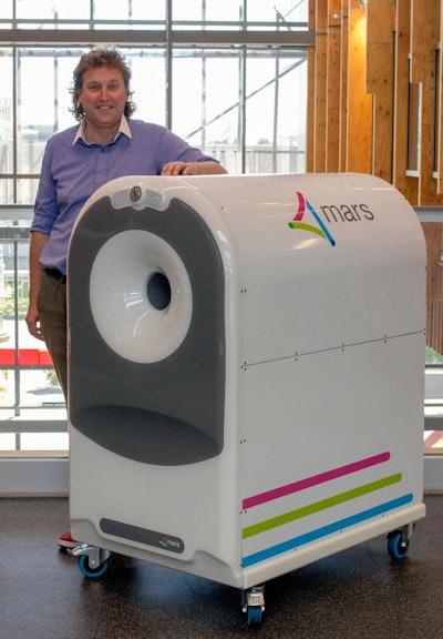 Butler with his MARS wrist scanner. Image courtesy of the University of Otago.