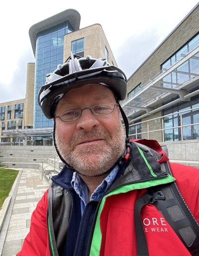 Dr. Paul McCoubrie arrives at work on his bike.