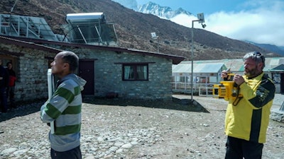 Michael Cairnie of MinXray takes a chest x-ray of Ang Kaji, head sherpa for Project Khumbu, during an expedition in April 2022. Image courtesy of Dr. Saurabh Jha.