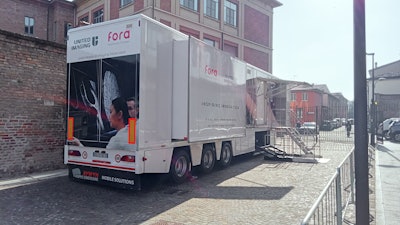 United Imaging's mobile digital PET/CT unit stands parked outside a hospital in Piacenza, Italy.