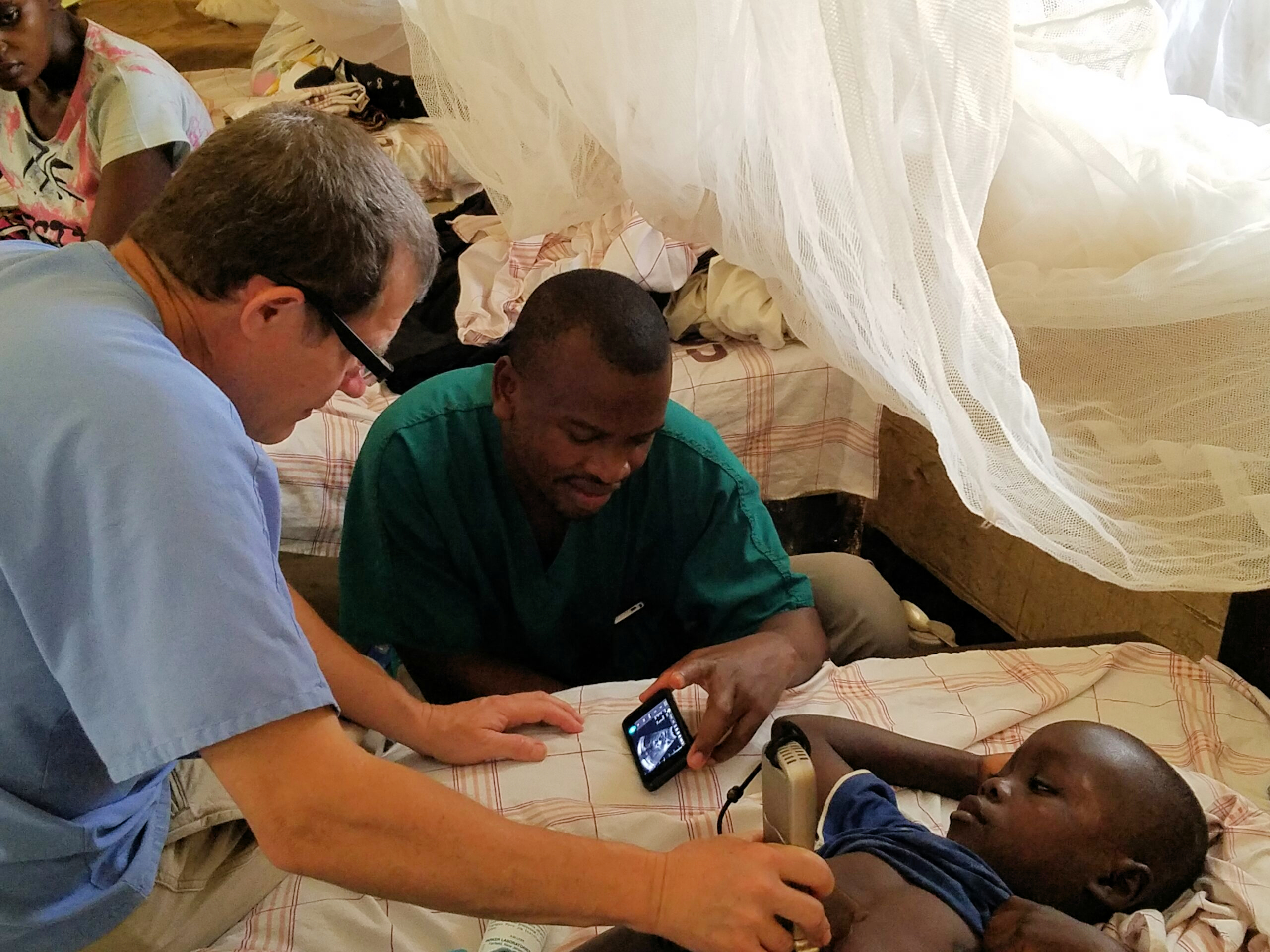 The clinical team perform an ultrasound scan at the Nyankunde Hospital, the Democratic Republic of the Congo, where Dr. Warren Cooper has performed operations ranging from repairing broken bones to craniotomies for over a decade.