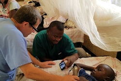 The clinical team perform an ultrasound scan at the Nyankunde Hospital, the Democratic Republic of the Congo, where Dr. Warren Cooper has performed operations ranging from repairing broken bones to craniotomies for over a decade.