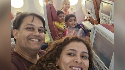 The selfie of the family taken onboard the Air India flight before take-off.