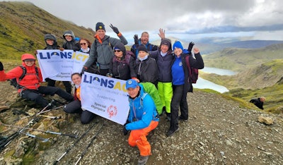 We made it! Members of LionsACT celebrate their achievement on the summit of Snowdon (Yr Wyddfa) on 13 September. Erik Ranschaert is standing in the center, holding the banner. Radiographer Sheryl Keppler is to the left of him. Erik’s wife, Annelies Van De Poel, is second from the right.