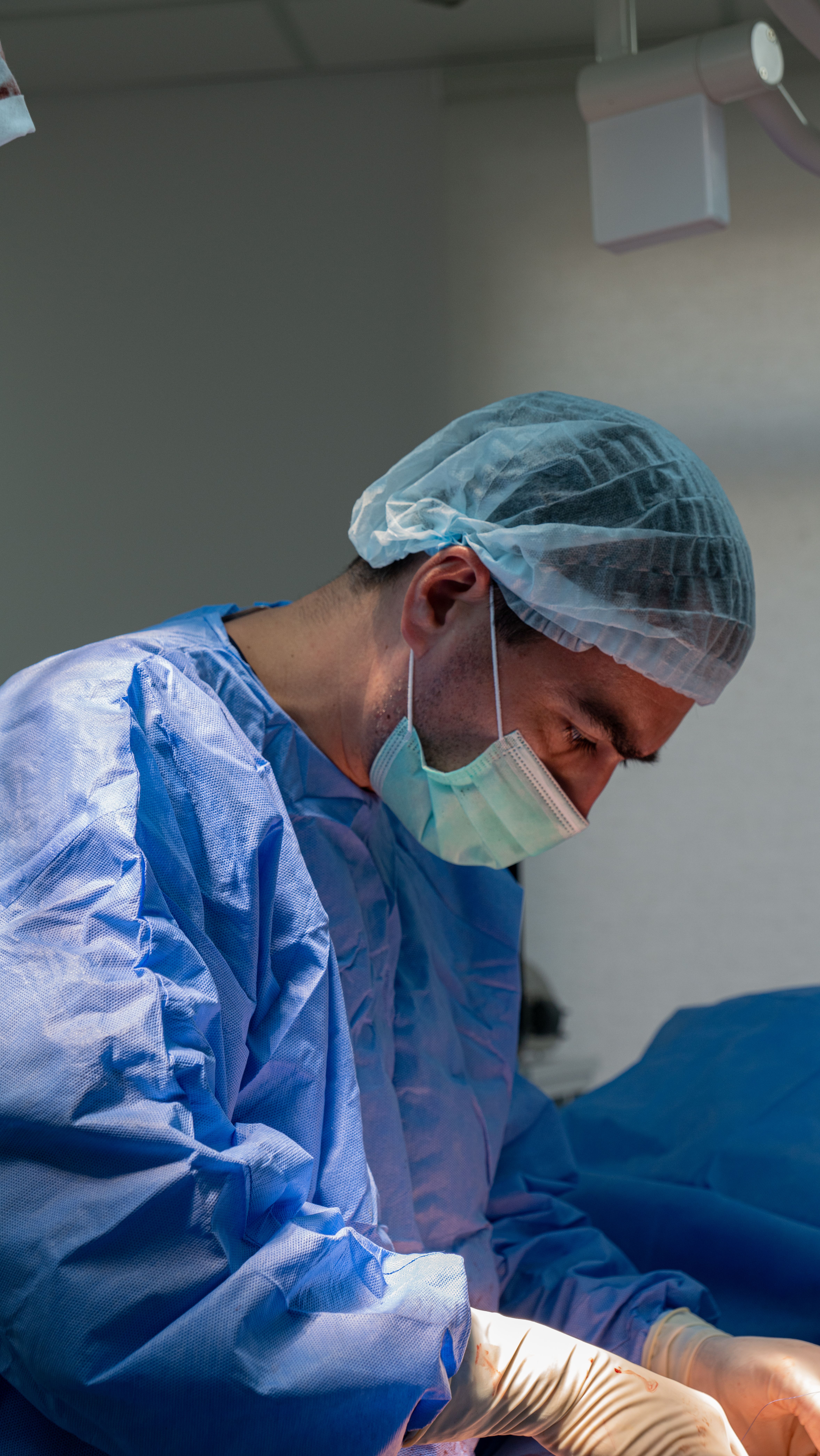 Surgeon performs a carotid artery procedure.
