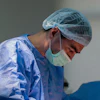 Surgeon performs a carotid artery procedure.