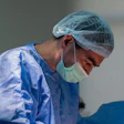 Surgeon performs a carotid artery procedure.