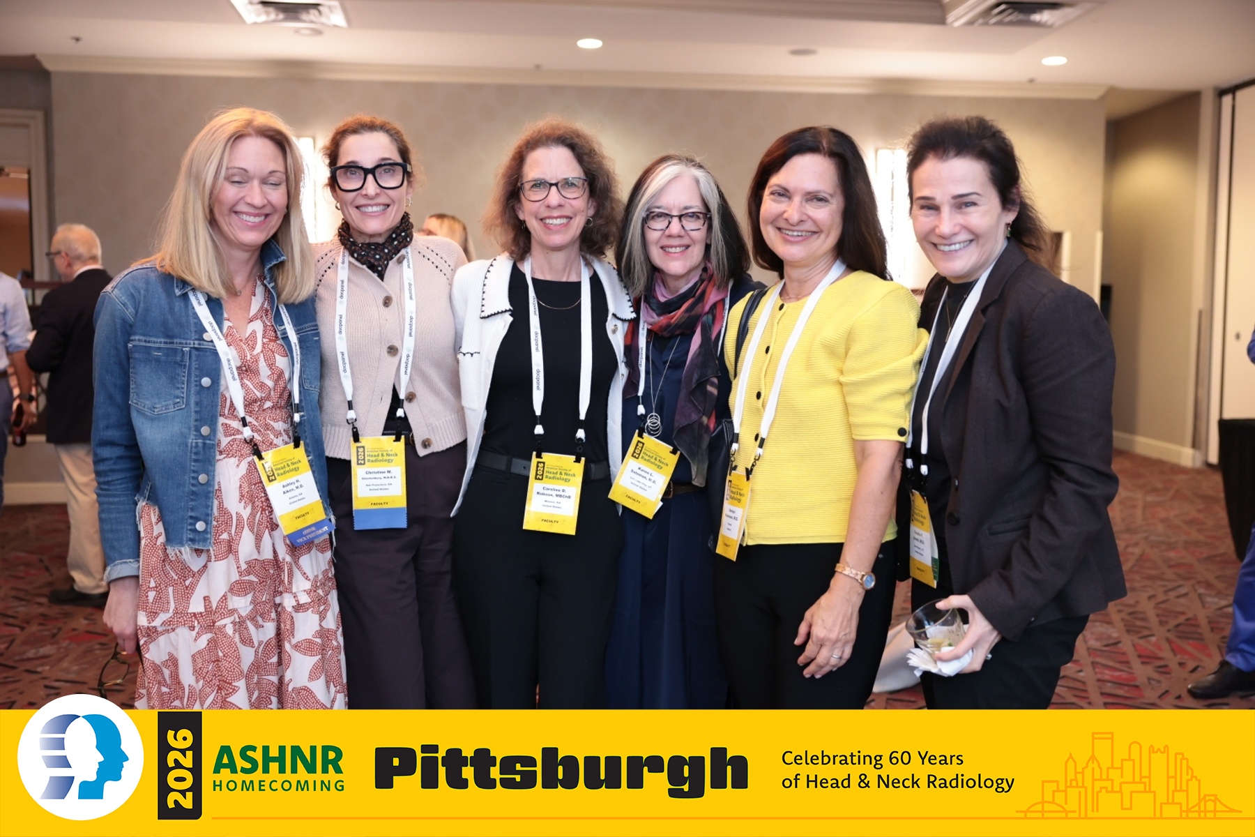 Six women smile together at ASHNR Pittsburgh Homecoming event celebrating 60 years of Head & Neck Radiology, all wearing credential badges