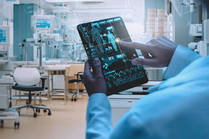 Healthcare professional in blue scrubs examining digital analytics on tablet in modern medical laboratory