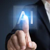 Businessman touching glowing AI symbol on digital interface representing artificial intelligence technology