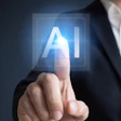 Businessman touching glowing AI symbol on digital interface representing artificial intelligence technology
