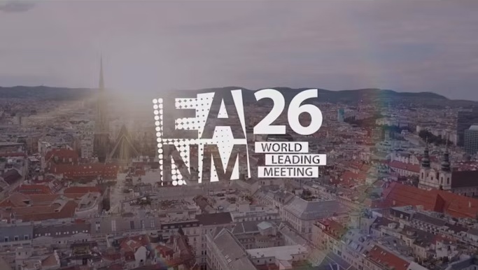 A26 NMM World Leading Meeting event branding overlaid on aerial cityscape at sunset