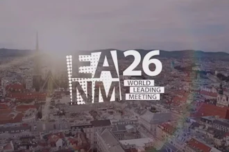 A26 NMM World Leading Meeting event branding overlaid on aerial cityscape at sunset