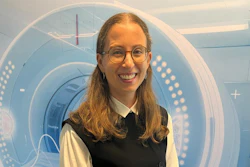 Smiling woman with glasses wearing professional black and white attire in front of futuristic blue circular design