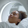 Patient relaxing inside an MRI scanner with illuminated circular ring during medical imaging procedure