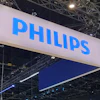 Philips brand name displayed on large blue and white suspended banner at indoor trade show booth