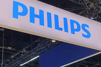Philips brand name displayed on large blue and white suspended banner at indoor trade show booth