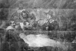 Historical black and white photograph showing men gathered around a table examining a deceased person during what appears to be a medical or forensic procedure.