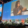 Panel discussion at ISTAT26 conference in Vienna with speaker presenting on stage while seated panelists listen