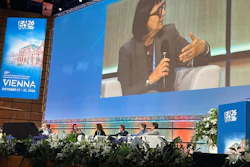 Panel discussion at ISTAT26 conference in Vienna with speaker presenting on stage while seated panelists listen