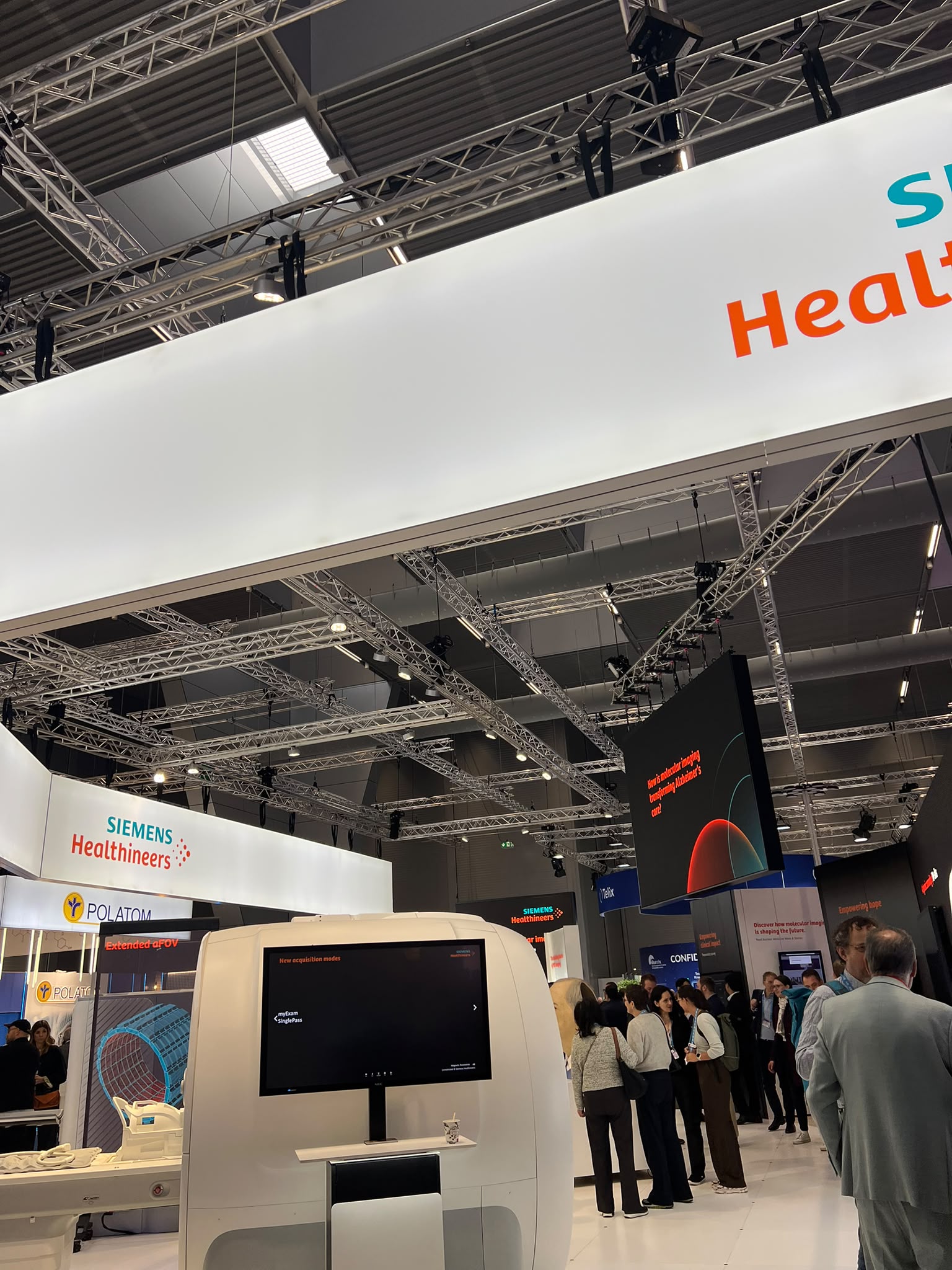 Siemens Healthineers trade show booth with interactive display at industrial exhibition venue