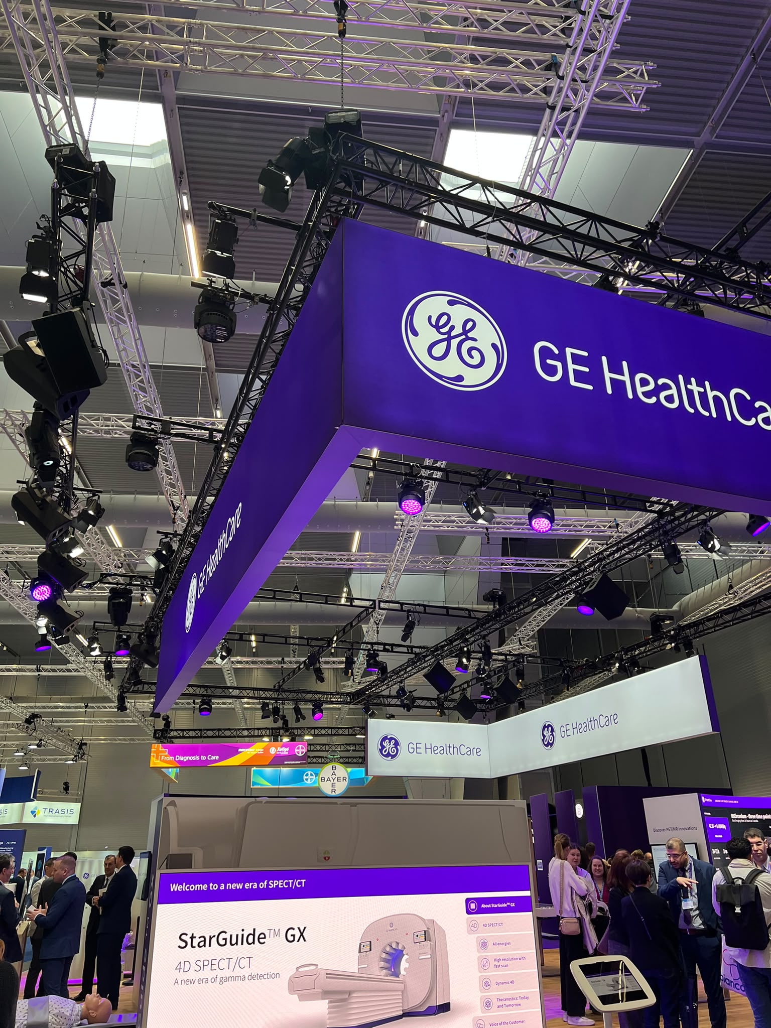 GE HealthCare exhibition booth at medical conference showcasing StarGuide GX 4D SPECT/CT imaging technology with professional lighting and attendees